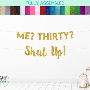 Puede incluir: Pancarta dorada con purpurina con el texto "ME? THIRTY? Shut Up!" colgada en una pared blanca.