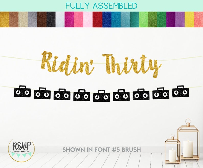 May include: Gold glitter banner with the text "Ridin' Thirty" and black cassette tape cutouts. The banner is fully assembled and shown in font #5 brush.