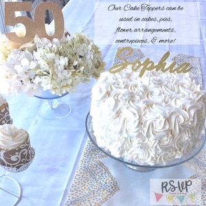May include: Gold glitter cake topper with the number 50 on it. The topper is on a white cake with white frosting and a gold glitter name topper that says "Sophia".