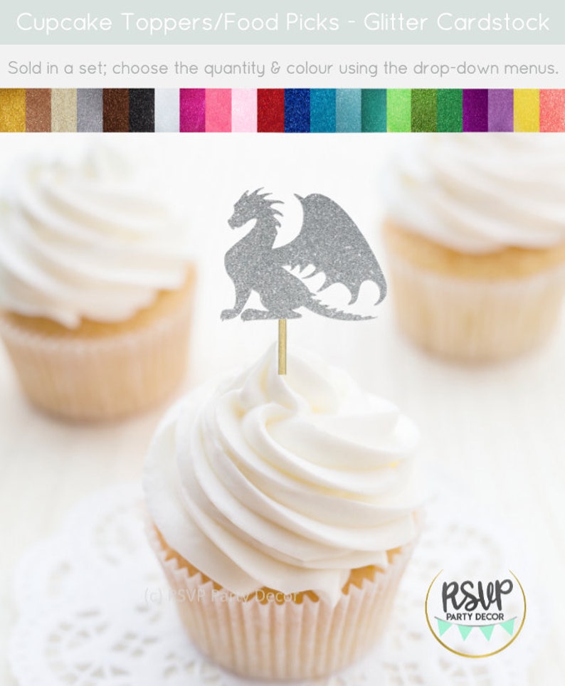 May include: Silver glitter dragon cupcake topper with wings. The topper is on a cupcake with white frosting. The cupcake is on a white doily. The image also shows a color chart of glitter cardstock.