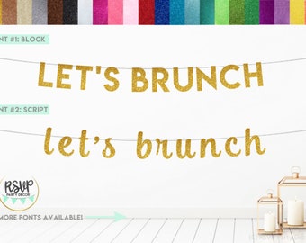 May include: Gold glitter banner with the text "LET'S BRUNCH" in block letters and "let's brunch" in script letters. The banner is hanging on a white wall with a wooden floor.
