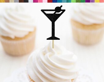 May include: Black glitter cupcake topper shaped like a martini glass with an olive. The topper is on a wooden stick and is shown on top of a cupcake. The text "RSVP Party Decor" is visible in the bottom right corner of the image.