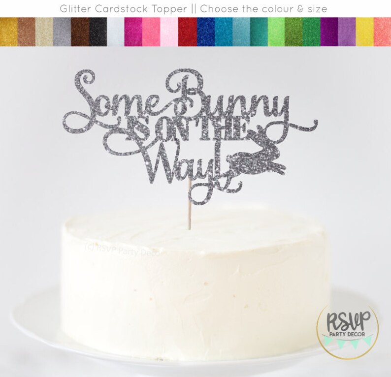 May include: Silver glitter cake topper with the text "Some Bunny is on the Way" and a bunny silhouette.