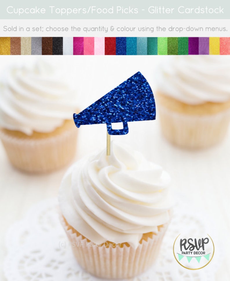 May include: A cupcake topped with a blue glitter megaphone-shaped food pick. The cupcake has white frosting and sits on a white doily. The image includes other cupcakes and a color palette.