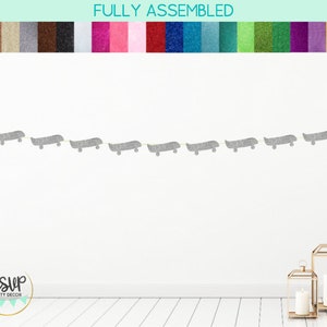 Op de afbeelding: Een zilveren glitter skateboard banner met de tekst "RSVP Party Decor" op een witte achtergrond.