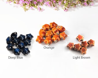 May include: Three groups of ceramic star-shaped beads in different colors: deep blue, orange, and light brown.