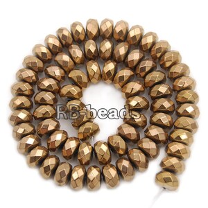 May include: A strand of gold-toned faceted beads. The beads are round and have a faceted, or diamond-like, finish. The beads are strung on a wire and are ready to be used in jewelry making.