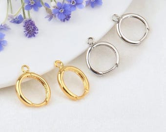 May include: Two pairs of hoop earring findings, one pair is gold and the other is silver. The findings have a small loop at the top for attaching a charm or pendant.