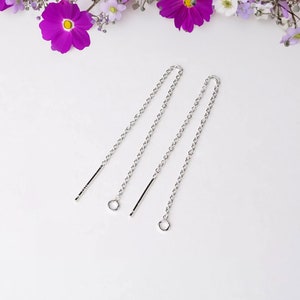 May include: Two silver chain earring extenders with a small loop at the end of each chain.