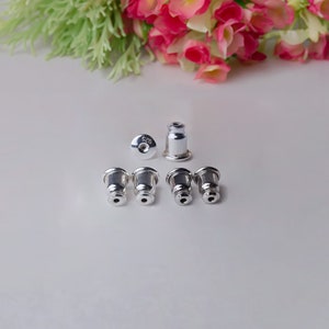 Peut inclure: Six dos d'oreille en argent, dont un portant le marquage "925", qui indique l'argent sterling.