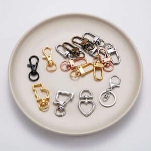 Llavero con cierre de langosta giratorio, llavero en forma de D, llavero de metal con cierre de mosquetón, colores dorado, plateado, bronce, goma y negro.