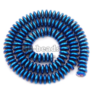 May include: A necklace of blue, disc-shaped beads with a metallic finish. The beads are strung together in a spiral. The image includes the text "rb-beads".