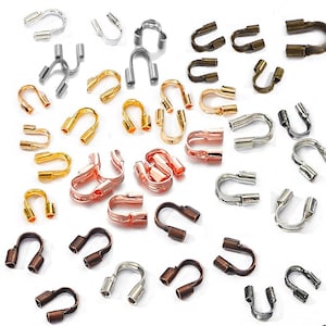 May include: Assortment of metal crimp end caps in various colors, including gold, silver, rose gold, and bronze. The crimp end caps are used for jewelry making and are designed to secure the ends of cords and chains.