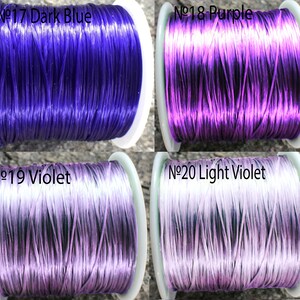May include: Four spools of thread in different shades of blue and purple. The spools are labeled with numbers and color names: No. 17 Dark Blue, No. 18 Purple, No. 19 Violet, and No. 20 Light Violet.