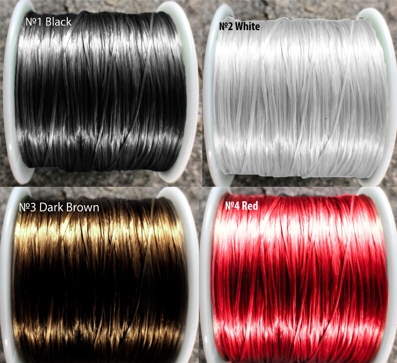 May include: Four spools of elastic cord in different colors: black, white, dark brown, and red. Each spool is labeled with a number and color.