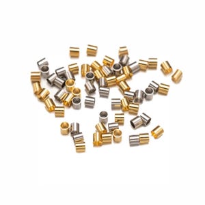 May include: A collection of gold and silver jump rings, a type of jewellery finding used for connecting chains, cords, and other jewellery components.