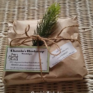 May include: A brown paper package tied with twine and a small sprig of greenery. A white label with the text "Chawin's Workshop Dominique" and contact information is attached. A second white label with the text "Thanks for supporting my small business! You're supporting my dream!" is also attached.