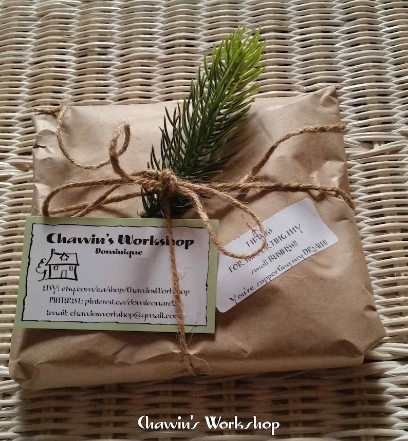 May include: A brown paper package tied with twine and a small sprig of greenery. A white label with the text "Chawin's Workshop Dominique" and contact information is attached. A second white label with the text "Thanks for supporting my small business! You're supporting my dream!" is also attached.