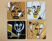 Funky faces in gold, white and black. Abstract face coasters on wooden coaster set of 4