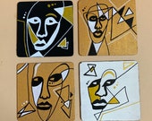 Funky faces in gold, white and black. Abstract face coasters on wooden coaster set of 4