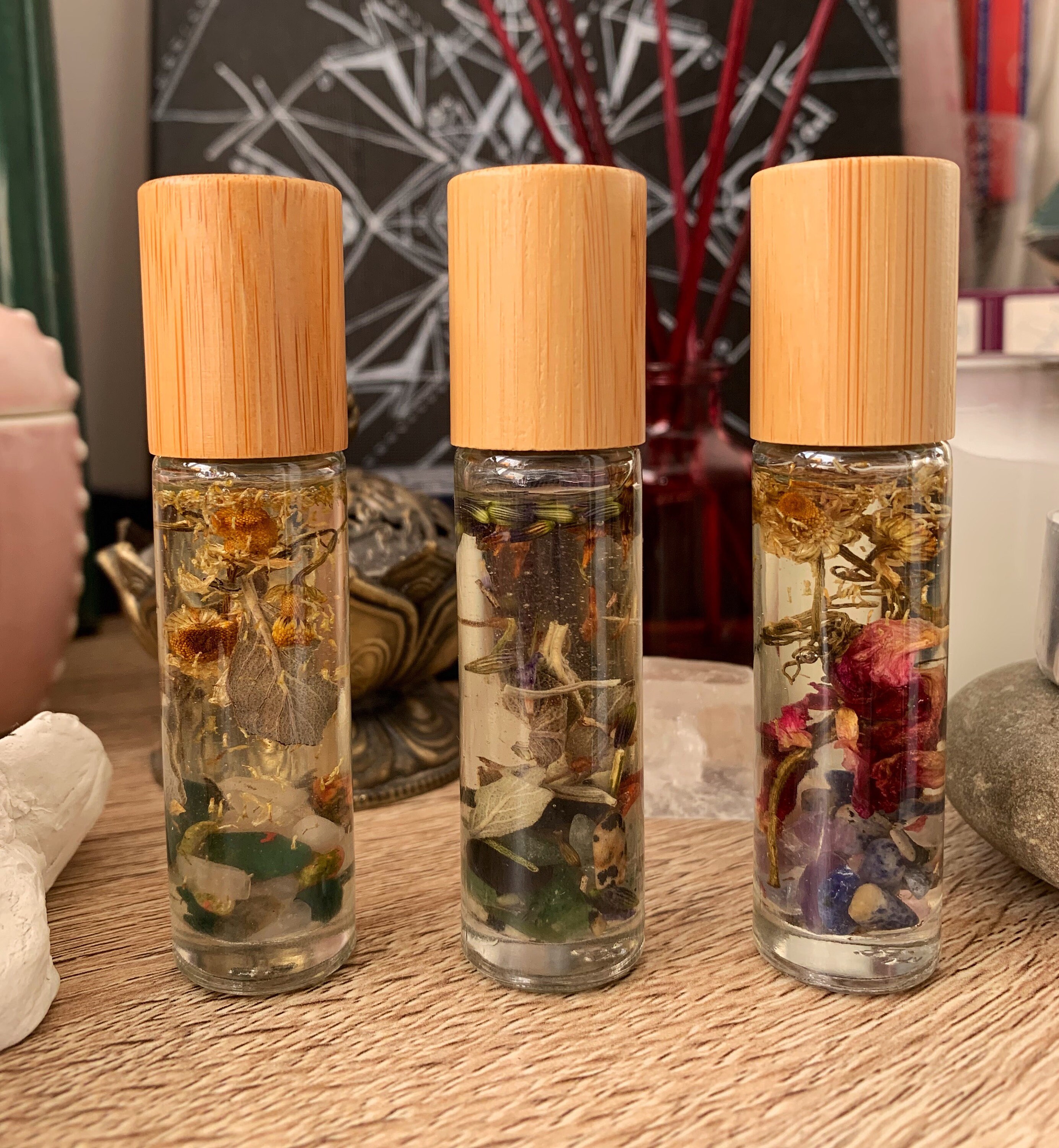 Essential oil rollers with crystals, dried herbs and flowers. Roll on…