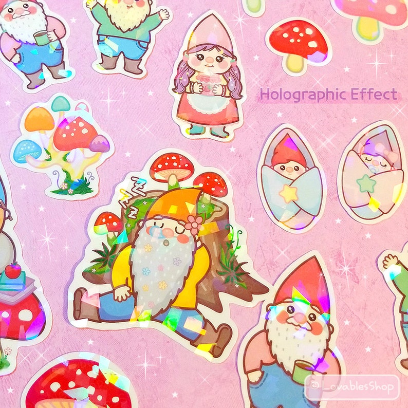 May include: A set of holographic stickers featuring gnomes, mushrooms, and stars. The stickers are on a pink background and have a holographic effect. The text "Holographic Effect" is printed on the sticker sheet.