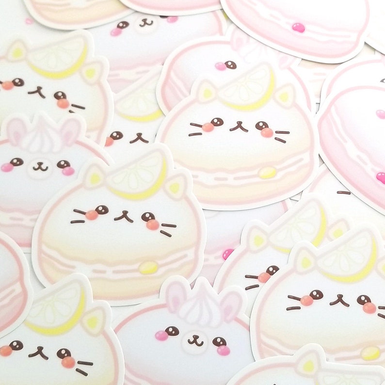 May include: A collection of pastel-colored stickers featuring cute cartoon animals, including cats and bunnies, with lemon slices and a macaron-like design. The stickers are perfect for adding a touch of whimsy to laptops, water bottles, or journals.