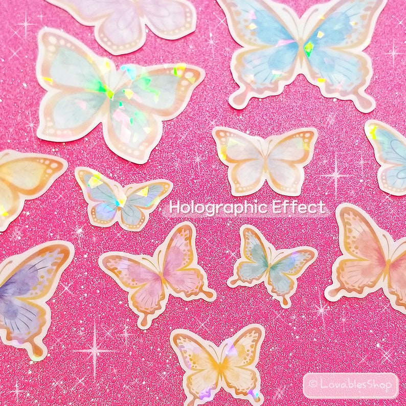May include: A sheet of holographic butterfly stickers with a pink glitter background. The stickers are in various colors, including blue, pink, and gold. The text "Holographic Effect" is printed on the sheet.