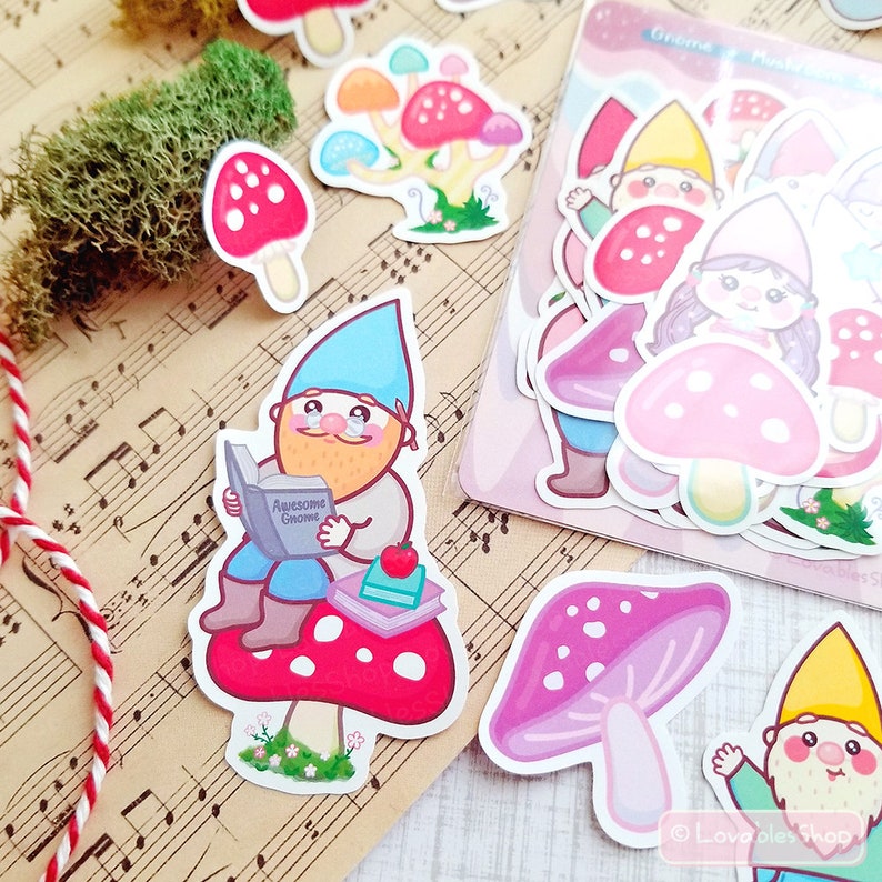 May include: A set of colorful gnome and mushroom stickers. The stickers feature gnomes wearing blue, yellow, and green hats, and mushrooms with red, pink, and white tops. The stickers are perfect for adding a touch of whimsy to your planner, laptop, or water bottle.