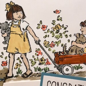 May include: A greeting card illustration featuring two children in yellow overalls, one pulling a red wagon with a dog inside while holding a cat, surrounded by colorful flowers. The text CONGRATULATIONS is partially visible at the bottom edge.