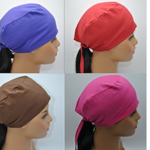 May include: Four solid-colored head wraps in blue, red, brown, and pink. Each wrap is tied at the back, with long ties hanging down. The head wraps are shown on a mannequin head.