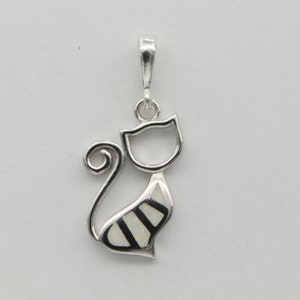 May include: A silver charm pendant in the shape of a cat with a white opal inlay. The cat is sitting with its tail curled around its body.