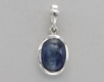 May include: A silver pendant with a blue oval gemstone set in a silver bezel.