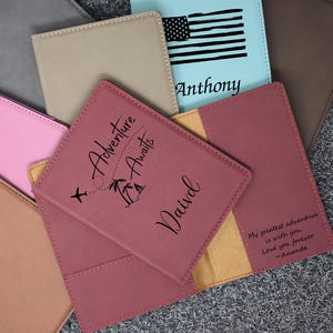May include: A set of passport holders in various colors, including pink, brown, gray, and blue. The holders feature personalized names and designs, such as an American flag and a plane flying over palm trees with the text "Adventure Awaits".