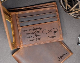 May include: A brown leather wallet with an engraved message that reads "I loved you yesterday, I love you still, I always have... I always will." The message is accompanied by an infinity symbol and a string of hearts. The name "Maggie" is engraved below the message. The wallet is open to reveal a second, smaller wallet with the name "Jam" engraved on it.
