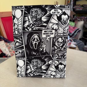 May include: A black and white comic book-style book cover featuring horror movie characters. The cover includes images of Freddy Krueger, Pennywise, Chucky, and the Ghostface mask. Text includes "What's your favourite scary movie?" and "You'll float too!"