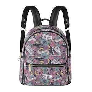 May include: A patterned backpack in shades of purple, pink, and teal, featuring roses, license plates, and other motifs. It has black straps, a gold zip, and a front pocket. The license plates read "KAZ 2Y5".