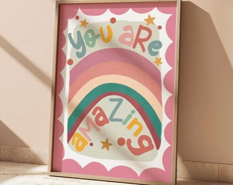 May include: A framed art print with a pink border displays a rainbow design and the words "you are amazing" in colourful letters. The print includes stars and a scalloped edge, with the text "+ no frames included".