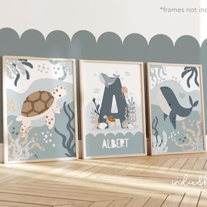 May include: Three framed prints with a blue, green and white ocean theme. The prints feature a turtle, a whale and the letter A with the name "Albert" below it.