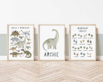 May include: Three framed prints with a dinosaur theme. The left print features a variety of dinosaurs with their names. The middle print features a single dinosaur with the name "Archie" below it. The right print features a chart of dinosaur footprints with their names.