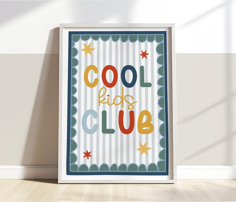 May include: A framed print with the words "COOL kids CLUB" in colorful letters. The background has vertical stripes, and the border is scalloped. Stars are scattered around the text.