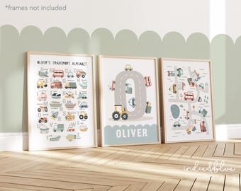 May include: Three framed art prints with transportation themes. The prints feature an alphabet, a road with vehicles, and a map with cars. The prints are in neutral colors with a light wood frame. The text "Oliver's Transport Alphabet" is visible.