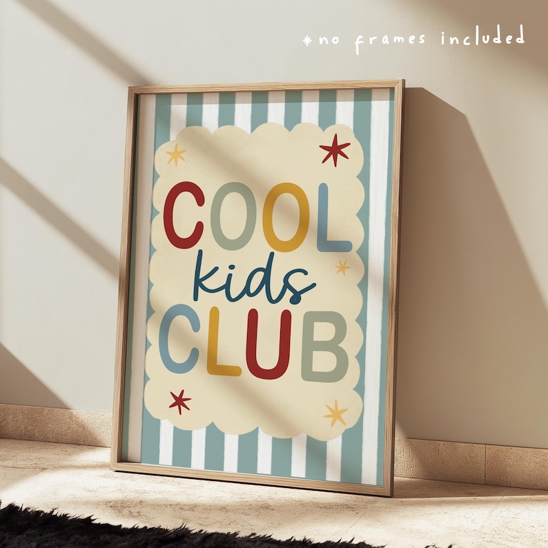 May include: A framed print with the words "COOL kids CLUB" in colorful letters. The text is on a cream-colored cloud-shaped background with a scalloped edge, set against a light blue and white striped backdrop. The frame is a light wood color.