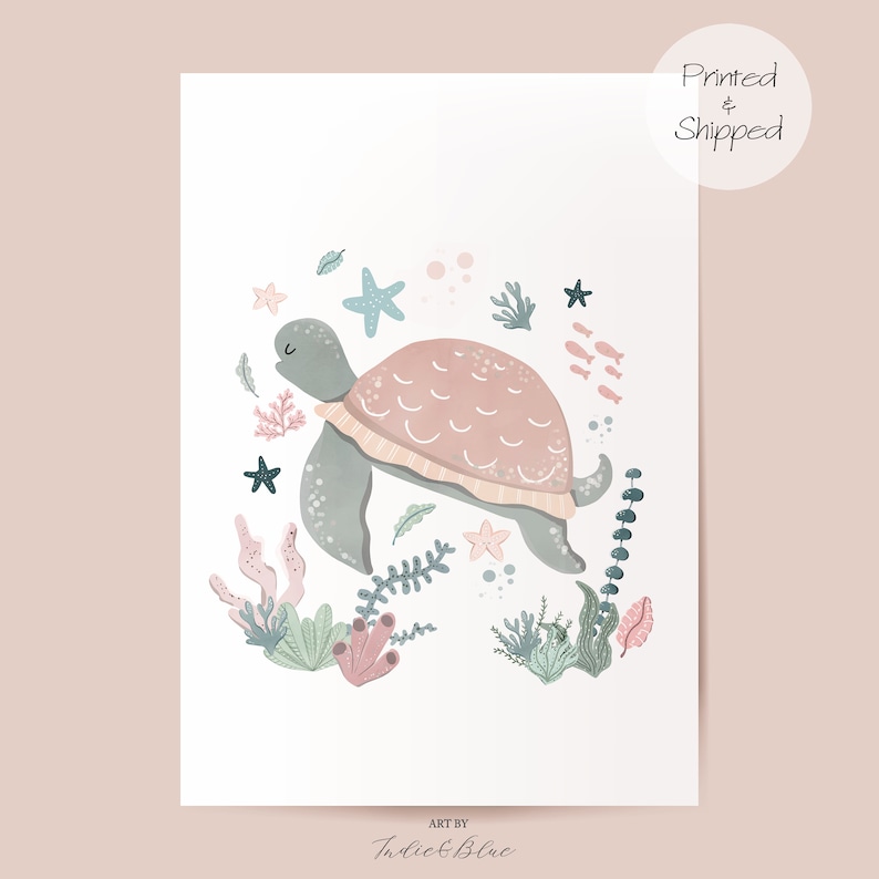 May include: A watercolor illustration of a pink and gray turtle swimming in a circle of coral, seaweed, and starfish. The text "Art by Indie & Blue" is at the bottom of the image.