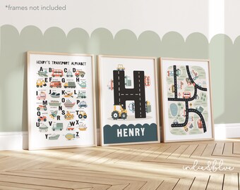 May include: Three framed prints with a transportation theme. The first print features a colorful alphabet with different vehicles for each letter. The second print features a large black letter H with a road and vehicles. The third print features a road map with vehicles and a green pond. The text on the second print reads "HENRY'S TRANSPORT ALPHABET" and "HENRY".