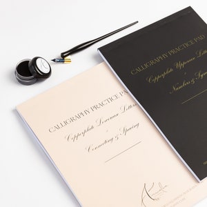 May include: Two calligraphy practice pads, one with a black cover and the other with a cream cover. The black pad features the text "Copperplate Uppercase Letters, Numbers & Symbols" in gold lettering. The cream pad features the text "Copperplate Lowercase Letters, Connecting & Spacing" in gold lettering. Both pads have the text "Calligraphy Practice Pad" in gold lettering.