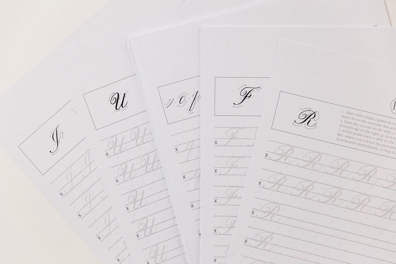 May include: Four sheets of paper with lined practice areas for cursive handwriting. Each sheet features a different letter of the alphabet: I, U, F, and R. The letter is written in cursive at the top of each sheet, with instructions for writing the letter below.