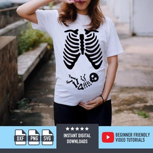 May include: White t-shirt with a black skeleton rib cage and fetus design. The shirt is worn by a person. The design is a humorous take on pregnancy. The shirt is a digital download.