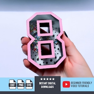 May include: A pink number eight-shaped shaker with a clear center filled with colorful confetti. The number has a black border and is held in a hand. The image also includes icons for digital downloads and video tutorials.