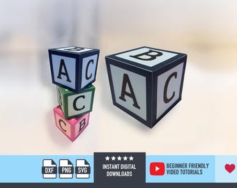 May include: Three colourful alphabet blocks, stacked and arranged. The blocks are white with black letters and borders, and the stacked blocks are green and pink. The image also includes the text "INSTANT DIGITAL DOWNLOADS" and "BEGINNER FRIENDLY VIDEO TUTORIALS."